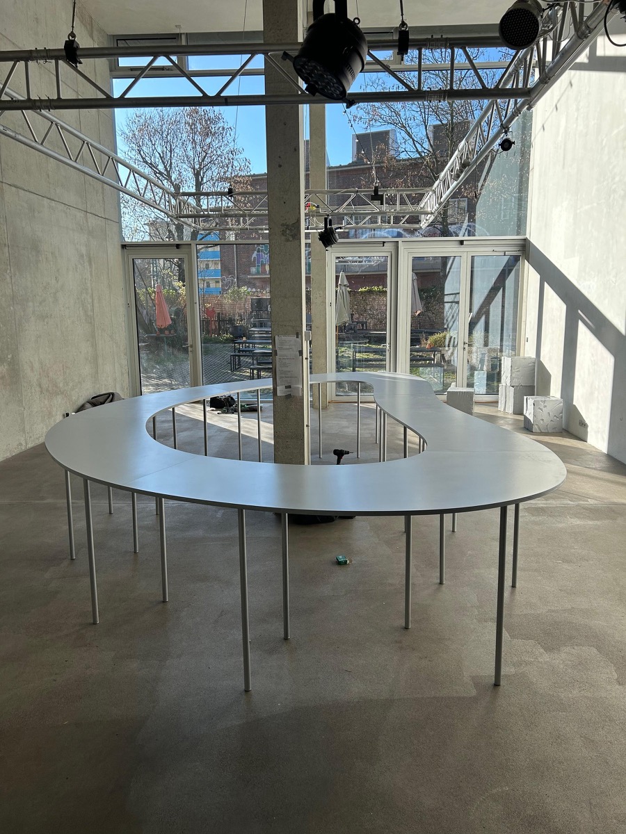 Maßgefertigter Eventtisch in einer Betonhalle mit Traversen